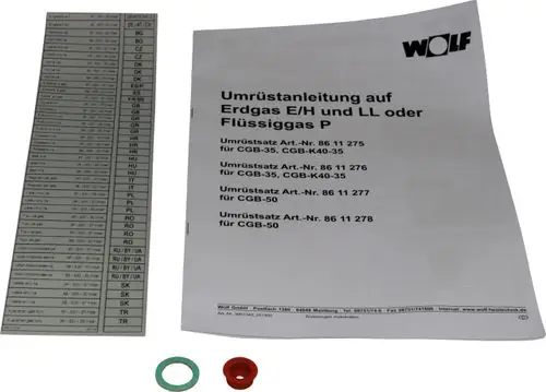 Umrüstsatz von Wolf mit Dokumentation für die Umrüstung auf Erdgas E/LL und Flüssiggas, einschließlich Adapter und Dichtungen, abgebildet neben einer Übersichtstabelle.
